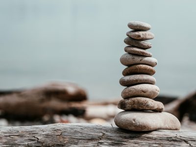 rock-stack-on-log-by-water